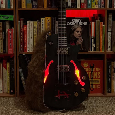 Bill Antonitis's finished baritone guitar, body centered, with its f-holes lit red from inside