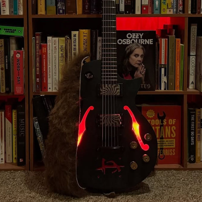 Bill Antonitis's finished baritone guitar, body centered, with its f-holes lit red from inside