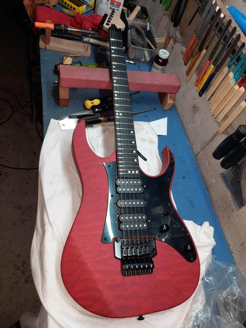 Customer-built red quilted maple JE-style guitar kit with Floyd Rose bridge — a completed DIY guitar kit build from Guitar Kit World