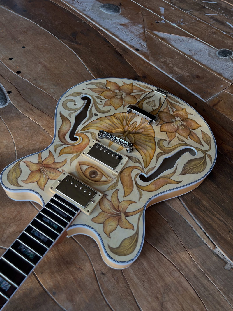 Angled view of the finished pencil-drawn guitar on a wooden floor