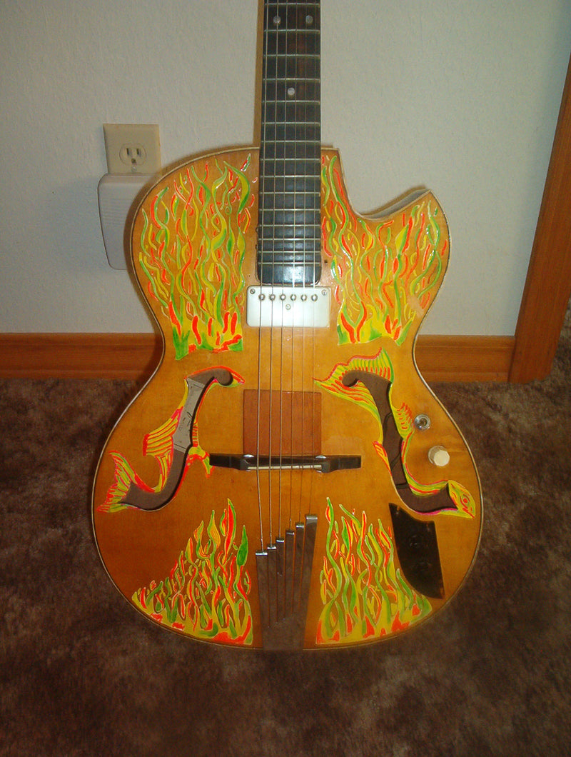 The same 1957 archtop, its top hand-painted with orange and green flames in 1968