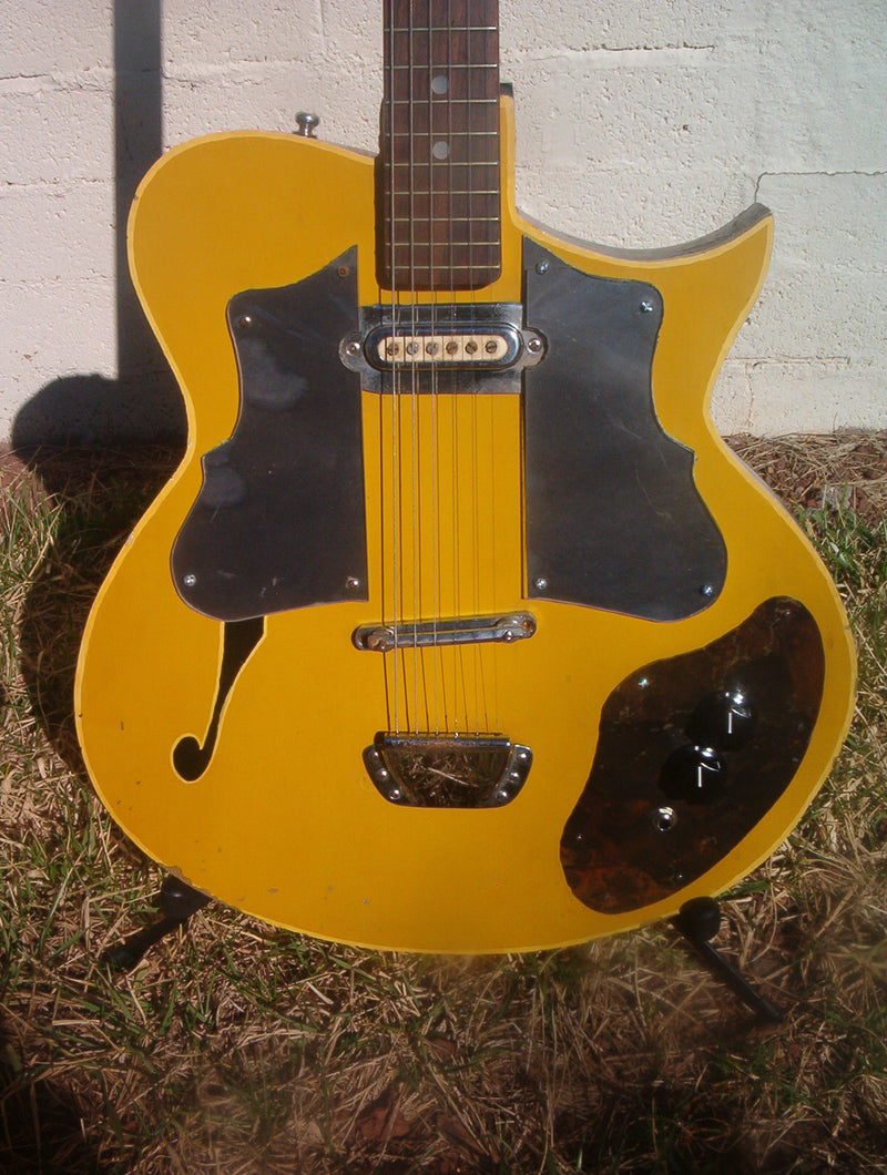 The same yellow scratch-built guitar today, its finish worn through from decades of gigging