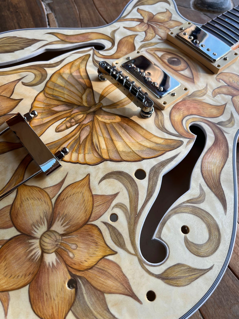 Guitar top in sepia and ochre colored pencil, lilies and scrollwork, flame maple grain showing through