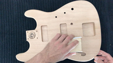 sanding the guitar