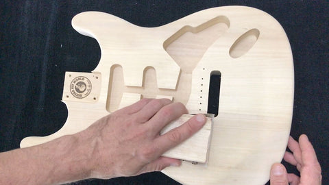 sanding the guitar