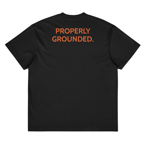 Black Properly Grounded Heavyweight Tee, orange Guitar Kit World logo, back view with PROPERLY GROUNDED. across the upper back
