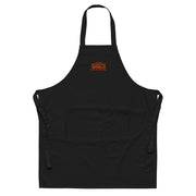 Black embroidered Sawdust and Solder Shop Apron with an orange stitched Guitar Kit World logo, front view