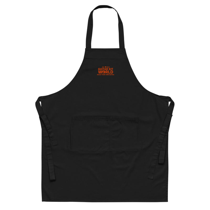 Black embroidered Sawdust and Solder Shop Apron with an orange stitched Guitar Kit World logo, front view