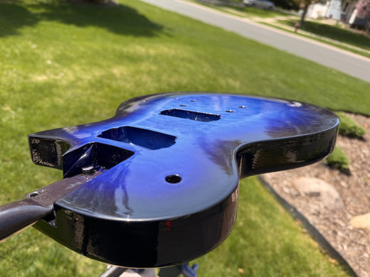 Full face of the glossy blue burst guitar body outdoors in daylight