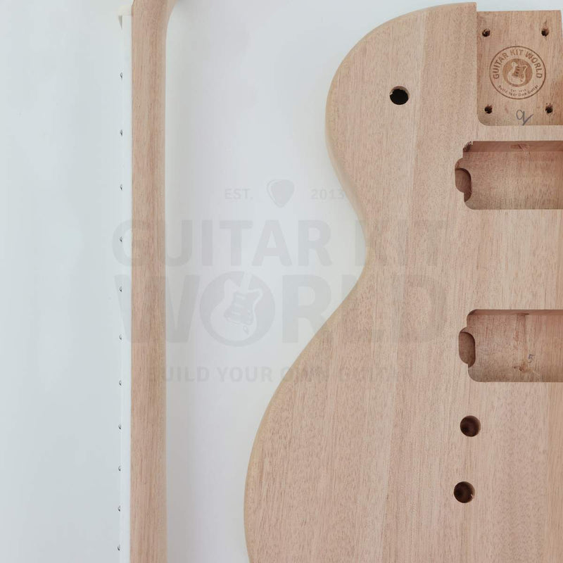 Bolt-on neck single-cutaway guitar kit with pre-wired electronics - mahogany body close-up of the neck pocket and pickup routes