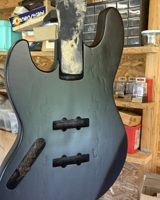 Satin black bass body after grain filling, the finish now even across the whole face