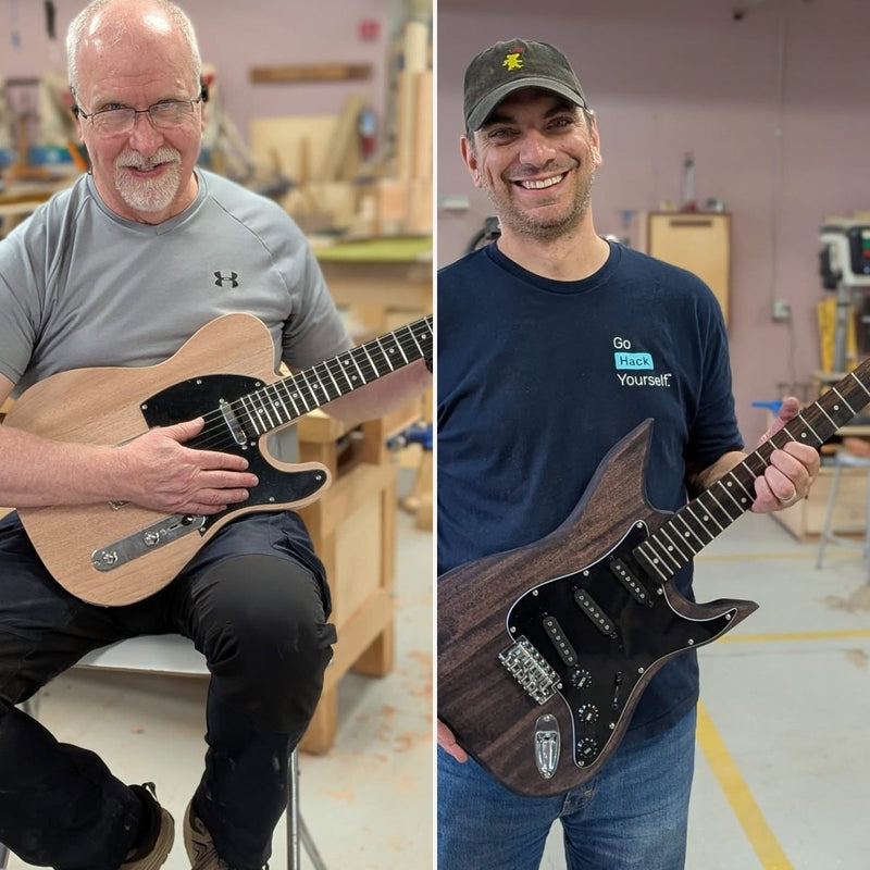 Two students holding the guitars they built