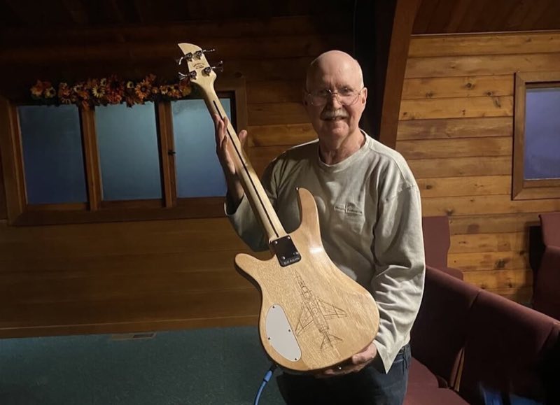 Flamed-maple bass with a lava-burst finish, built as a gift