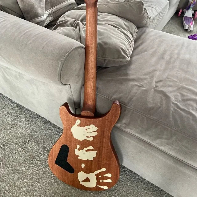 Andy Dion's family guitar build with kids' handprints on the back