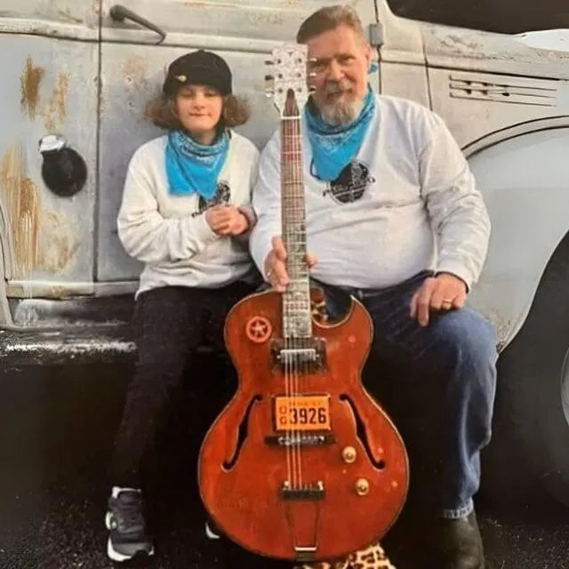 Ken Pfalzgraf and his daughter Tami with a junkpile guitar