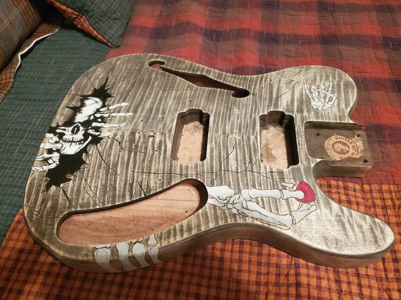 A finished DIY guitar resting in a quiet workshop